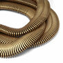 Close up of a gold plated bracelet made up of three strands and a chain extender.